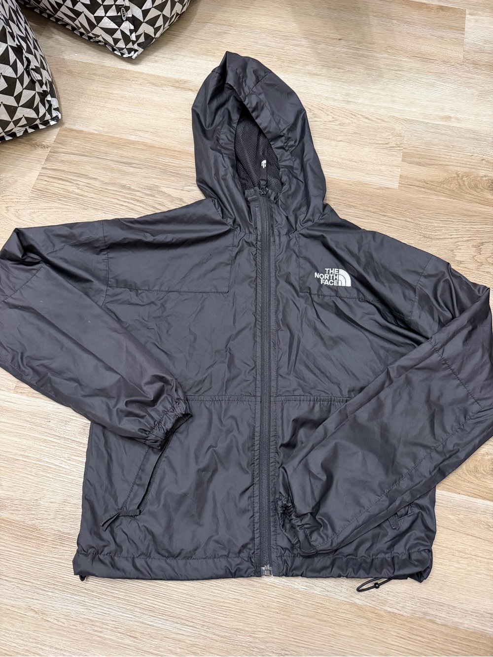 The North Face women’s Black Hooded Windbreaker Jacket